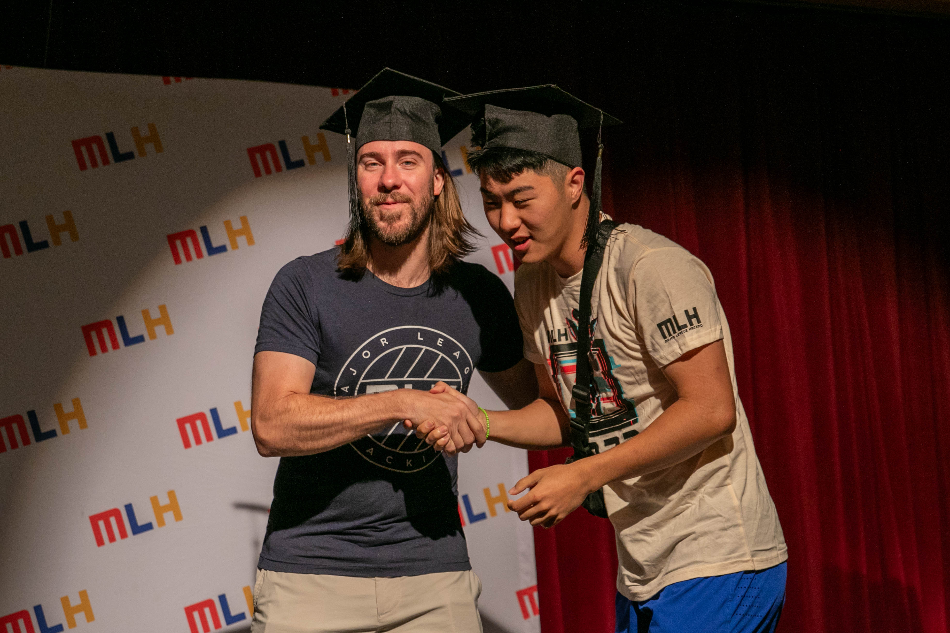 Kevin shaking hands with MLH CEO Mike Swift at HackCon